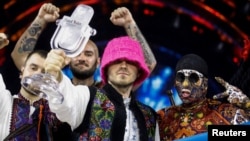 Ukraine's Kalush Orchestra pose after winning the 2022 Eurovision Song Contest in Turin, Italy, on May 15, with Oleh Psyuk brandishing the crystal award.