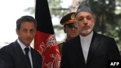 French President Nicolas Sarkozy (left) with Afghan President Hamid Karzai in Kabul on July 12.