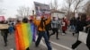 People march on the streets of Almaty to mark International Women's Day on March 8, 2021.