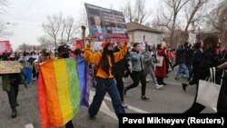 People march on the streets of Almaty to mark International Women's Day on March 8, 2021.