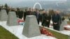 Kosovar President Hashim Thaci (right) visits a memorial in the village of Recak on International Human Rights Day.