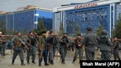 Afghan police keep watch at the site of a suicide attack outside a wedding hall in Kabul on November 16.