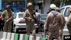 Members of the Iranian Revolutionary Guard secure the area outside the Iranian parliament after militants launched a deadly attack on the complex in Tehran on June 7.