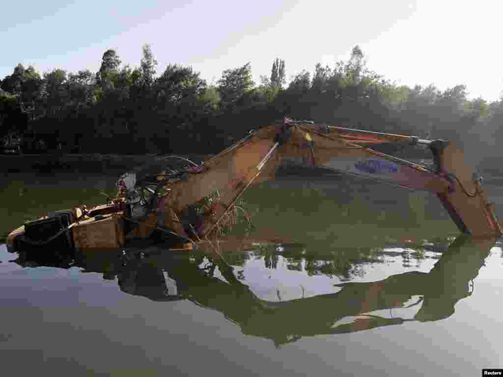 A piece of heavy equipment sits submerged after being carried away by a tsunami following Chile's earthquake. - Photo by Ivan Alvarado for Reuters