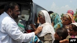د کډوالو په کیمپ کې ډاکټر د ښځو علاج کوي