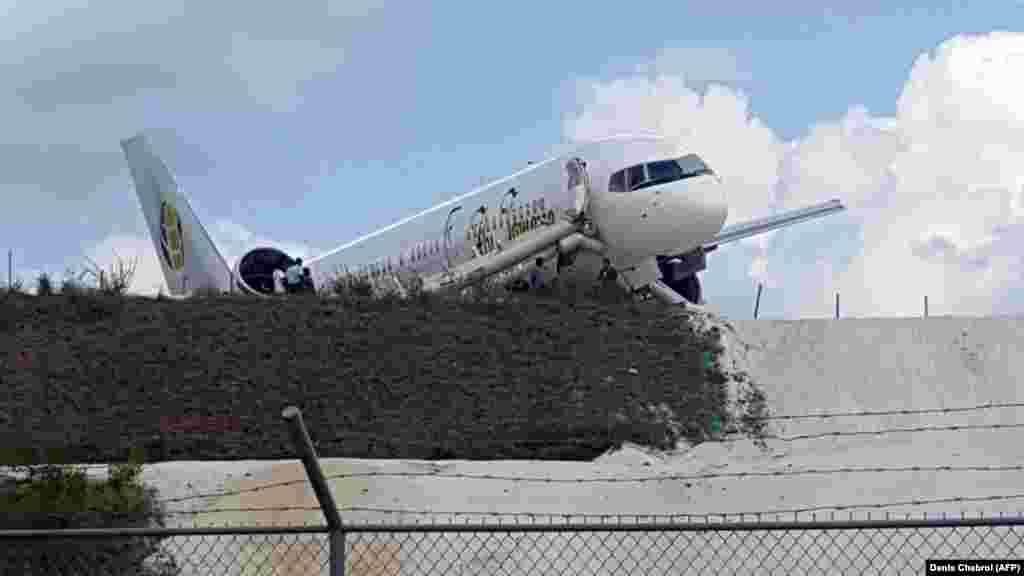 A Toronto-bound Fly Jamaica airplane lies prone after crash-landing at the Cheddi Jagan International Airport in Georgetown, Guyana on November 9. (AFP/Denis Chabrol)