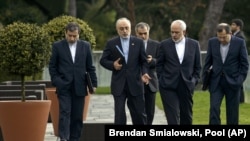 Head of Iranian Atomic Energy Organization, Ali Akbar Salehi, 2nd left, and Iranian Foreign Minister Javad Zarif, 2nd right, walk together during negotiations at an hotel in Lausanne, Switzerland, Sunday March 29, 2015.