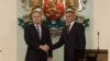 Bulgarian President Rumen Radev (left) and caretaker Prime Minister Stefan Yanev shake hands in Sofia after a new cabinet was sworn in on May 12. 