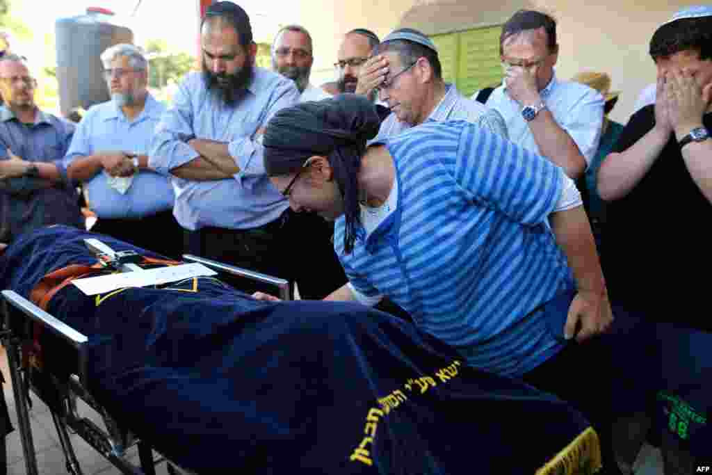 The mother of a 13-year-old Israeli girl who was fatally stabbed by a Palestinian attacker in her home mourns during her funeral in the Kiryat Arba settlement outside the Israeli-occupied West Bank city of Hebron on June 30. (AFP/Gil Cohen-Magen)