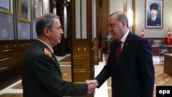 Turkish President Recep Tayyip Erdogan (right) greets the head of the Turkish Armed Forces General Staff, General Hulusi Akar, in Ankara in July.