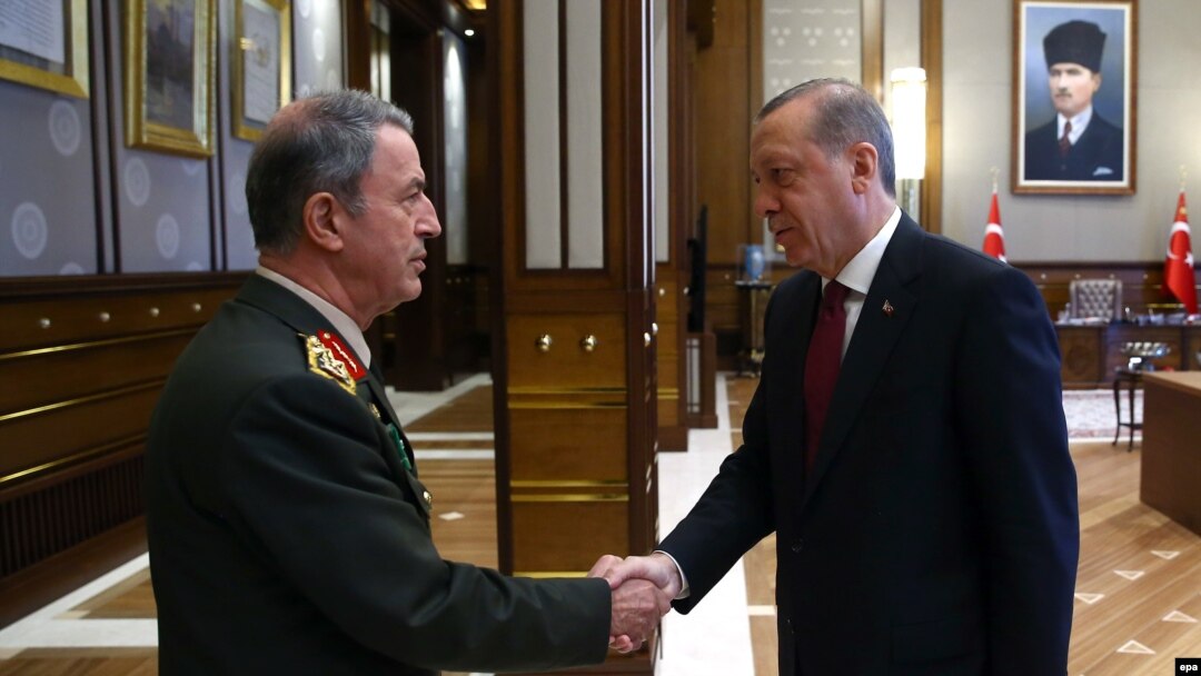 Turkish President Recep Tayyip Erdogan (right) greets the head of the Turkish Armed Forces General Staff, General Hulusi Akar, in Ankara in July.