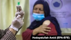 A medical worker prepares a dose of the Indian version of the AstraZeneca coronavirus vaccine at a hospital in Kabul.