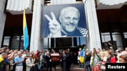 Men carrying the coffin of journalist Pavel Sheremet, who was killed by a car bomb in Kyiv, during a memorial service in the Ukrainian capital in July.