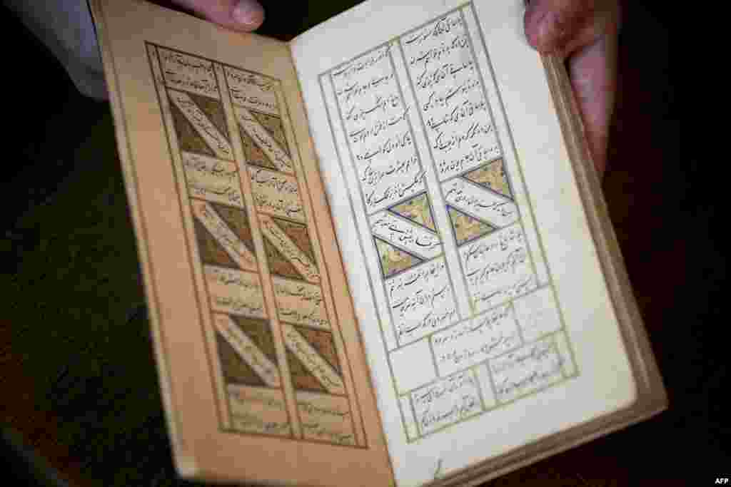 A stolen 15th-century book by the famed Persian poet Hafez has been recovered by a Dutch art detective after an international &quot;race against time&quot; that drew the alleged interest of Iran&#39;s secret service.(Photo by Kenzo TRIBOUILLARD / AFP)