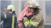 Emergency workers rescue children from a kindergarten in Kharkiv, which was targeted by Russian drones.