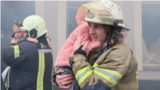 Emergency workers rescue children from a kindergarten in Kharkiv, which was targeted by Russian drones.