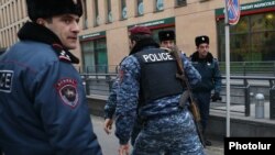 Armenia -- Armed policemen rush to Erebuni Plaza Business Center where a gunman opened fire, Yerevan, January 23, 2020.