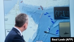 US General Dan Caine, chairman of the Joint Chiefs of Staff, speaks as a map of the Strait of Hormuz is displayed.