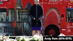 U.K. Prime Minister Theresa May lays a wreath of flowers on Parliament Square in Westminster on the anniversary of the Westminster Bridge attack in London on March 22.