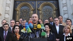 Georgian opposition politicians make a public statement in Tbilisi on March 27, indicating their intentions to have peaceful protests to call for Saakashvili's ouster.