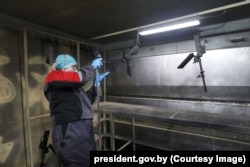 A technician works with gun barrels in the Kidma Tech facility.