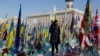 A woman reads inscriptions at a makeshift memorial on Kyiv's Independence Square for Ukrainian and foreign fighters who have fallen during Russia's invasion, on the third anniversary of the start of the all-out conflict on February 24. 