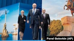 Russian President Vladimir Putin (center) arrives to attend a meeting with supporters in Moscow on January 30.