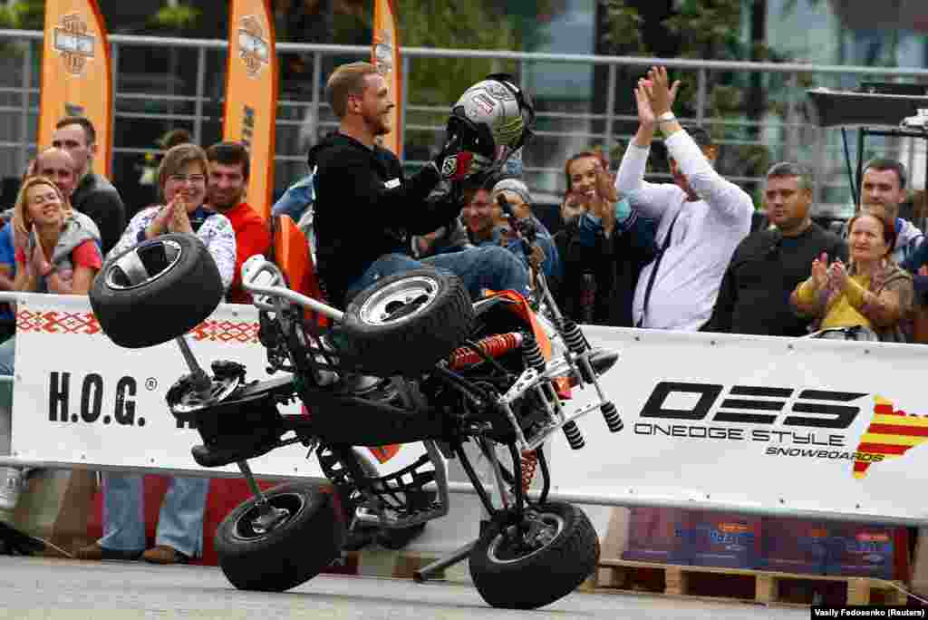 A man performs on a quadricycle during a rally in Minsk, Belarus, on September 13. (Reuters/Vasily Fedosenko)