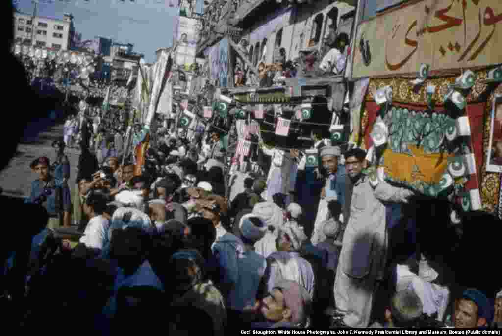 Crowds line a street in Peshawar to welcome the American first lady.&nbsp;