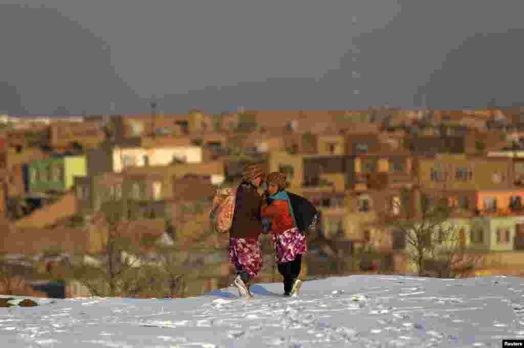 Afghan girls walk on snow as they head home in Kabul. (Reuters/Mohammad Ismail)