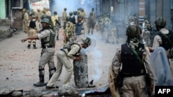 Indian security forces clear road blockades following clashes with Kashmiri protesters in Srinagar on August 29.