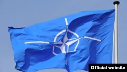 NATO flag flying at NATO Headquarters Brussels.