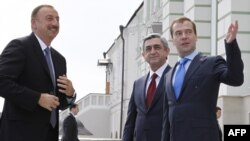 Russian President Dmitry Medvedev (right) greets his counterparts Serzh Serzh Sarkisian (center) and Ilham Aliyev during their meeting in Kazan on June 24.