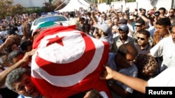 Mourners carry the coffin of slain opposition leader Muhammad Brahmi during his funeral procession in Tunis on July 27. 