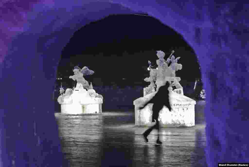 A skater glides past ice sculptures during an ice and snow sculpture festival near Almaty, Kazakhstan, on January 14.