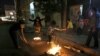 Iranian families light fire outside their houses in Tehran on March 13, 2018 during the Wednesday Fire feast, or Chaharshanbeh Soori, held annually on the last Wednesday eve before the Spring holiday of Noruz. The Iranian new year that begins on March 20