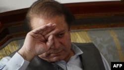 Incoming Pakistani Prime Minister Nawaz Sharif wipes his brow during a meeting with journalists at his house on the outskirts of Lahore on May 13.