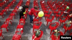 Children place flowers and balloons on chairs in Sarajevo in April 2012 to honor more than 11,000 children killed in the Bosnian war.