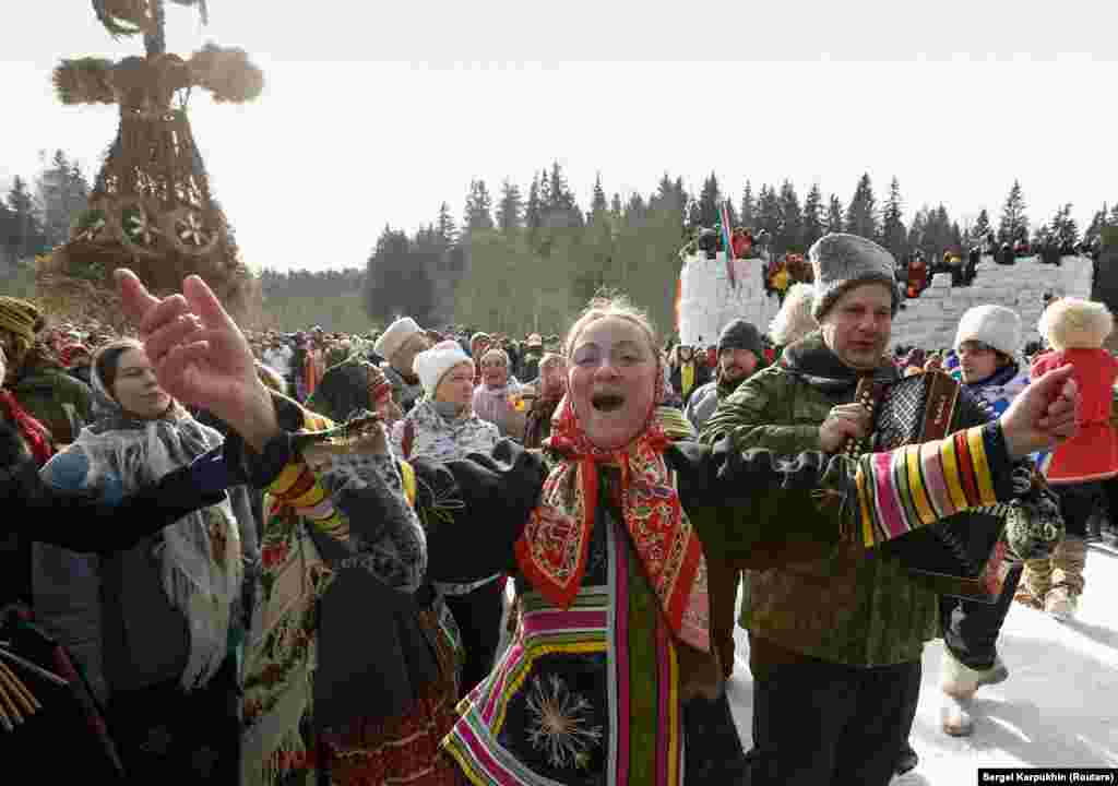 A woman dancing in front of Lady Maslenitsa near Moscow on February 26. Despite its pagan roots, the festival has been folded into Orthodox Christian traditions.&nbsp;