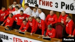 Deputies representing the Udar party led by Vitali Klitschko block the speaker's rostrum during a session of parliament in Kyiv on February 5.