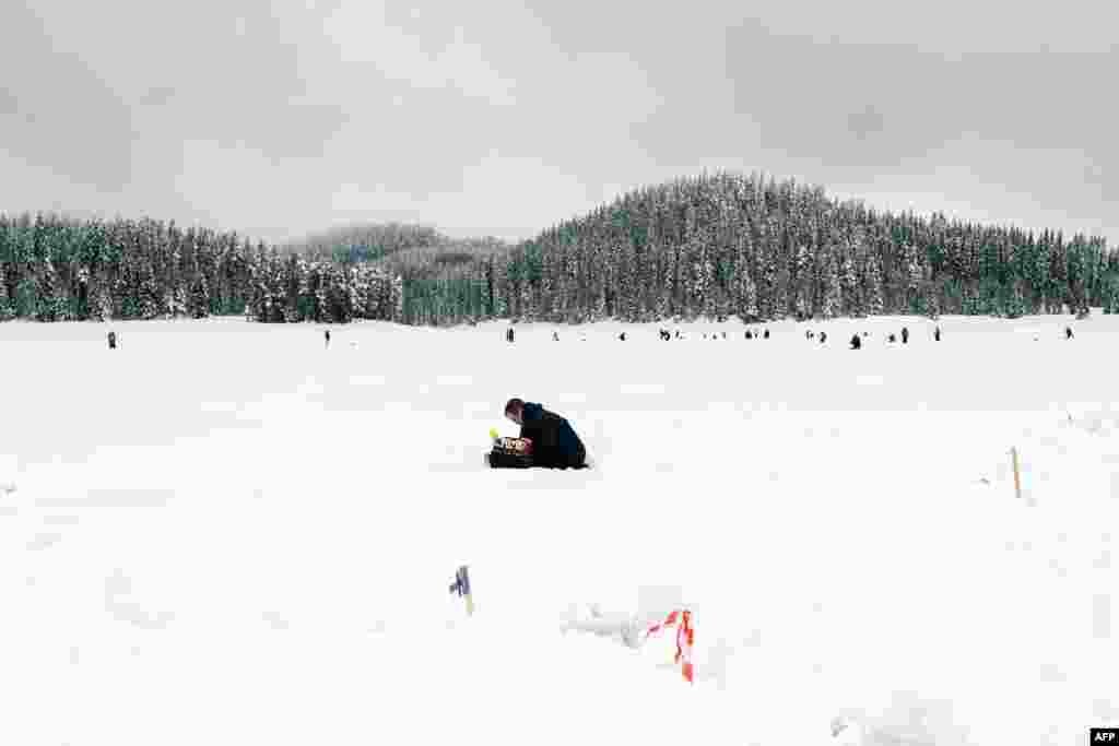 BULGARIA -- An angler takes part in the XVI World Ice Fishing Championship in Shiroka Polyana dam near Batak on January 26, 2019.