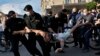 Police officers detain a protester during a rally in Minsk on June 19.