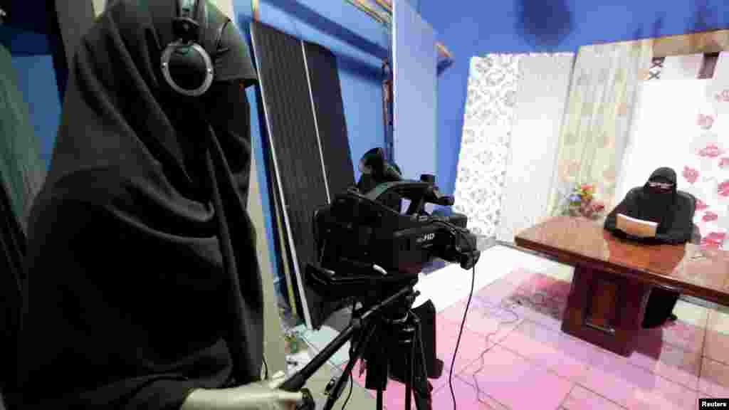 Recording a program in the studio of a new Egyptian TV channel, which is being managed and run exclusively by women who wear the full veil, on July 19. (REUTERS/Mohamed Abd El Ghany)