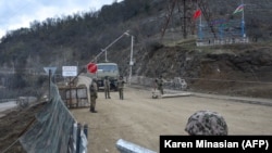 NAGORNO-KARABAKH -- Azerbaijani soldiers patrol at a checkpoint on a road outside the town of Shushi (Susa), November 26, 2020