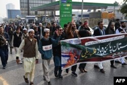 Youth activists of Muslim Talba Mahaz holding a banner shout slogans during a protest against Iran's air strike, in Islamabad on January 18.