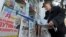 A man looks through a newspaper at a kiosk with Russian newspapers displayed outside in the Crimean port of Sevastopol on March 27.