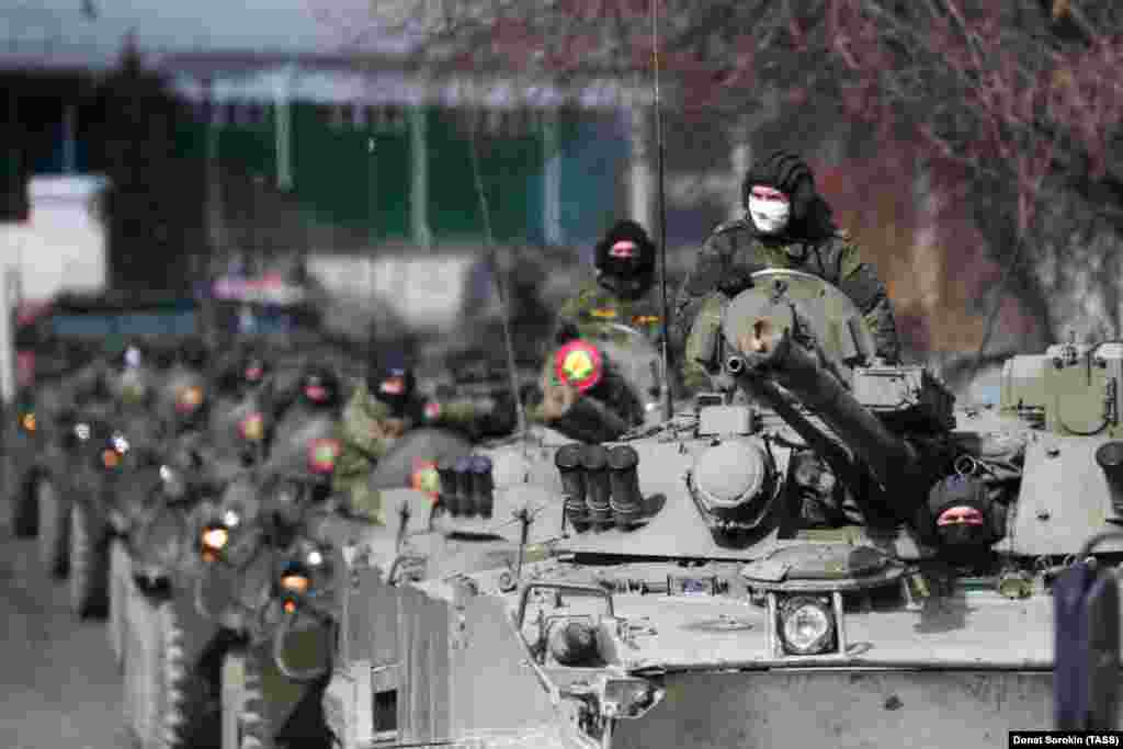 Masked Russian servicemen drive armored vehicles along a Yekaterinburg street during Victory Day parade rehearsals on April 14. Parades will be held in Yekaterinburg and Moscow on May 9, but the Russian capital remains under lockdown to slow the spread of the coronavirus.