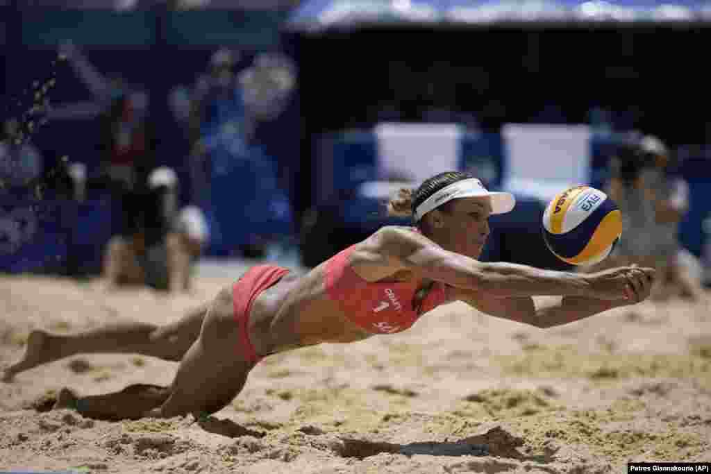Anouk Verge-Depre, of Switzerland, dives for the ball during a women's beach volleyball match against Brazil at the 2020 Summer Olympics, Tuesday, Aug. 3, 2021, in Tokyo, Japan.