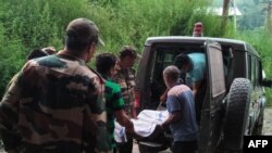 FILE: Indian soldiers and medical workers shift the body of slain soldier to a morgue in Rajouri, near Jammu.