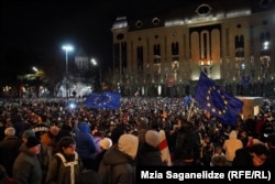 Protesters rally outside the parliament building in Tbilisi on November 28.